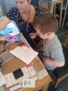 Charlie having a go with the stamps